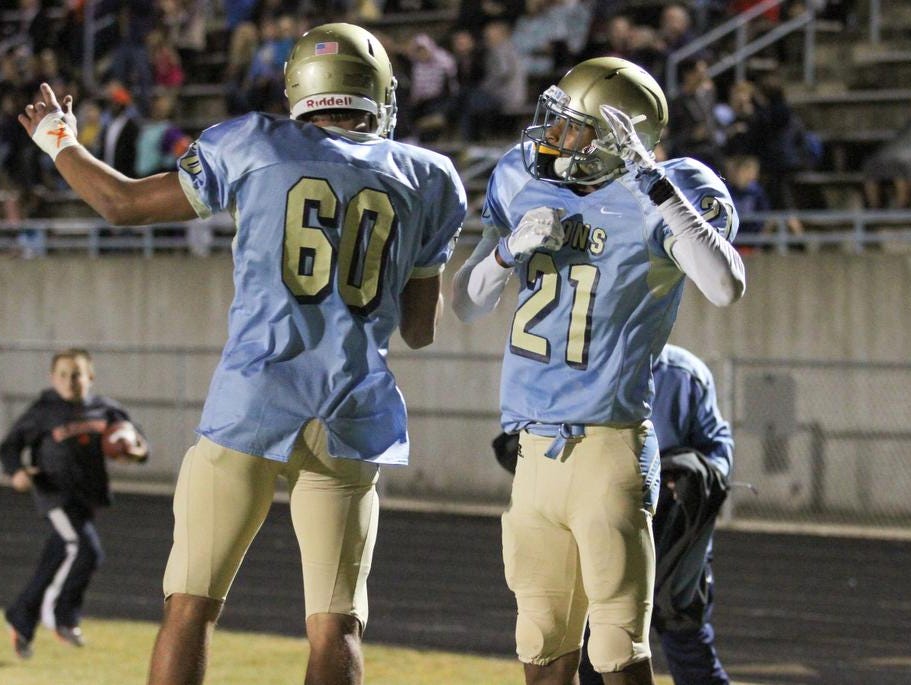 Daniel reciever CJ Scott (21) celebrates with teammate Dylan Perry (60) after scoring a touchdown against Seneca.