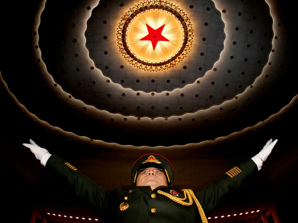 A military band conductor practices during a rehearsal before the opening of the fifth session of the 12th Chinese People's Political Consultative Conference National Committee at the Great Hall of the People in Beijing.