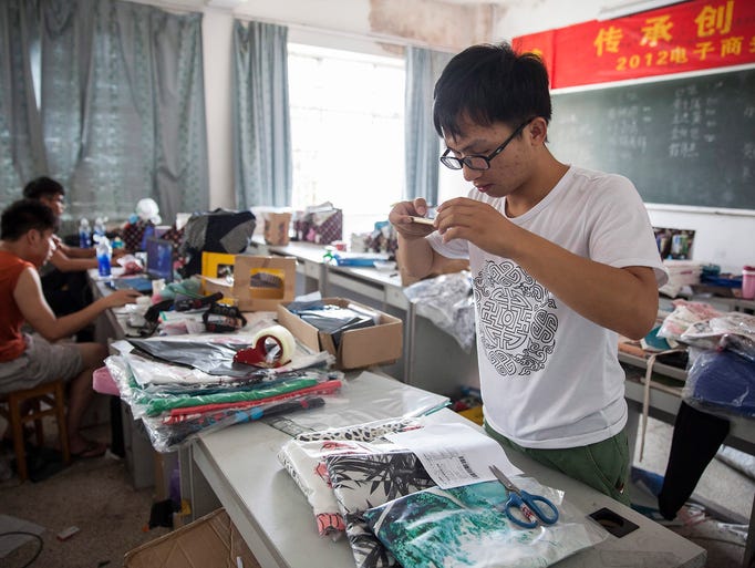 Meng Longfei photographs receipts and goods for archive at the Institute of Entrepreneurship at Yiwu Industrial and Commercial College in Yiwu City.