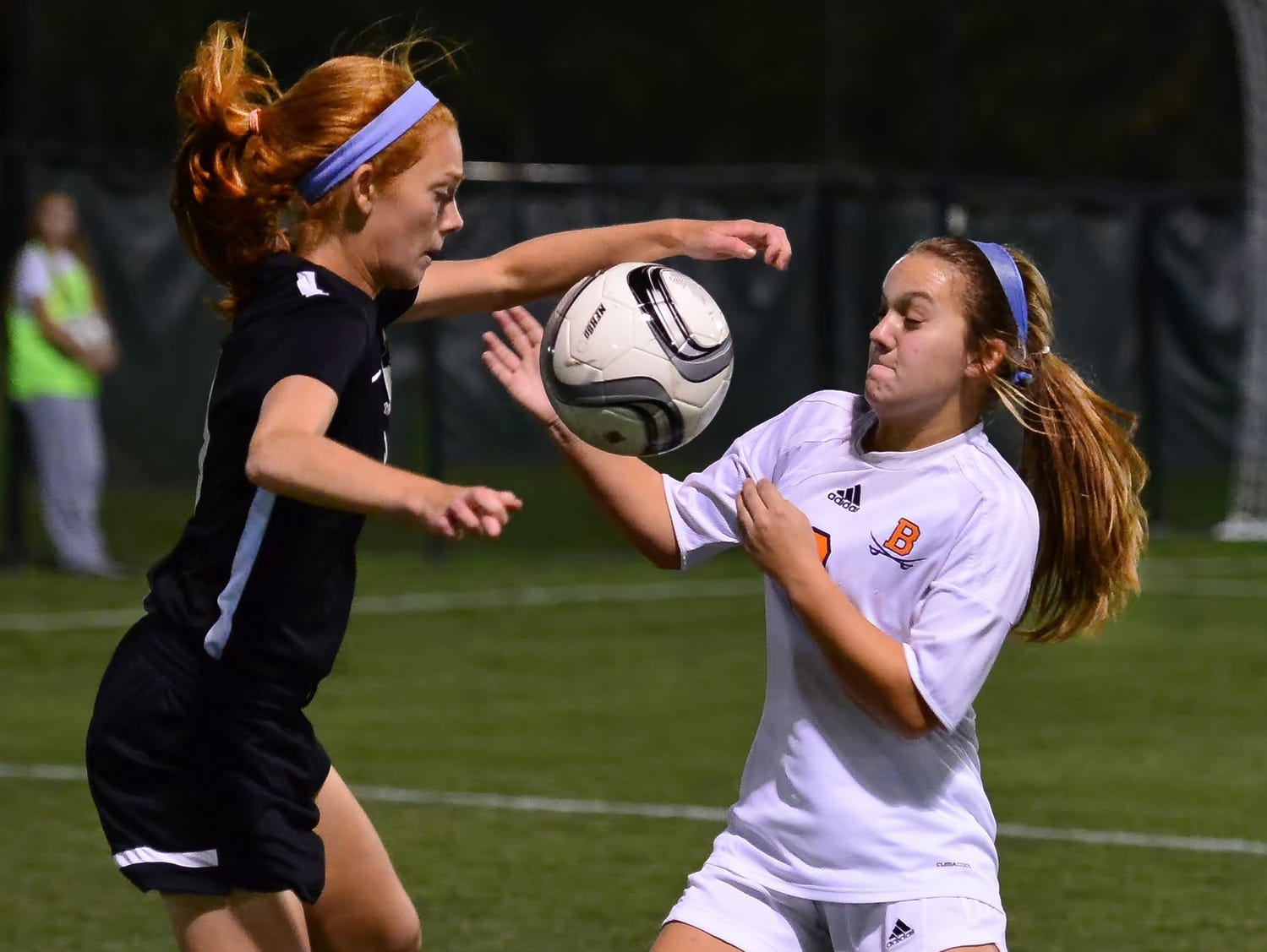 Station Camp High junior Megan Brinkley battles with Beech sophomore Natalie Lankster for possession. Brinkley scored a goal and provided an assist during the Lady Bison's 3-0 victory in Tuesday evening's District 9-AAA Tournament semifinal match.