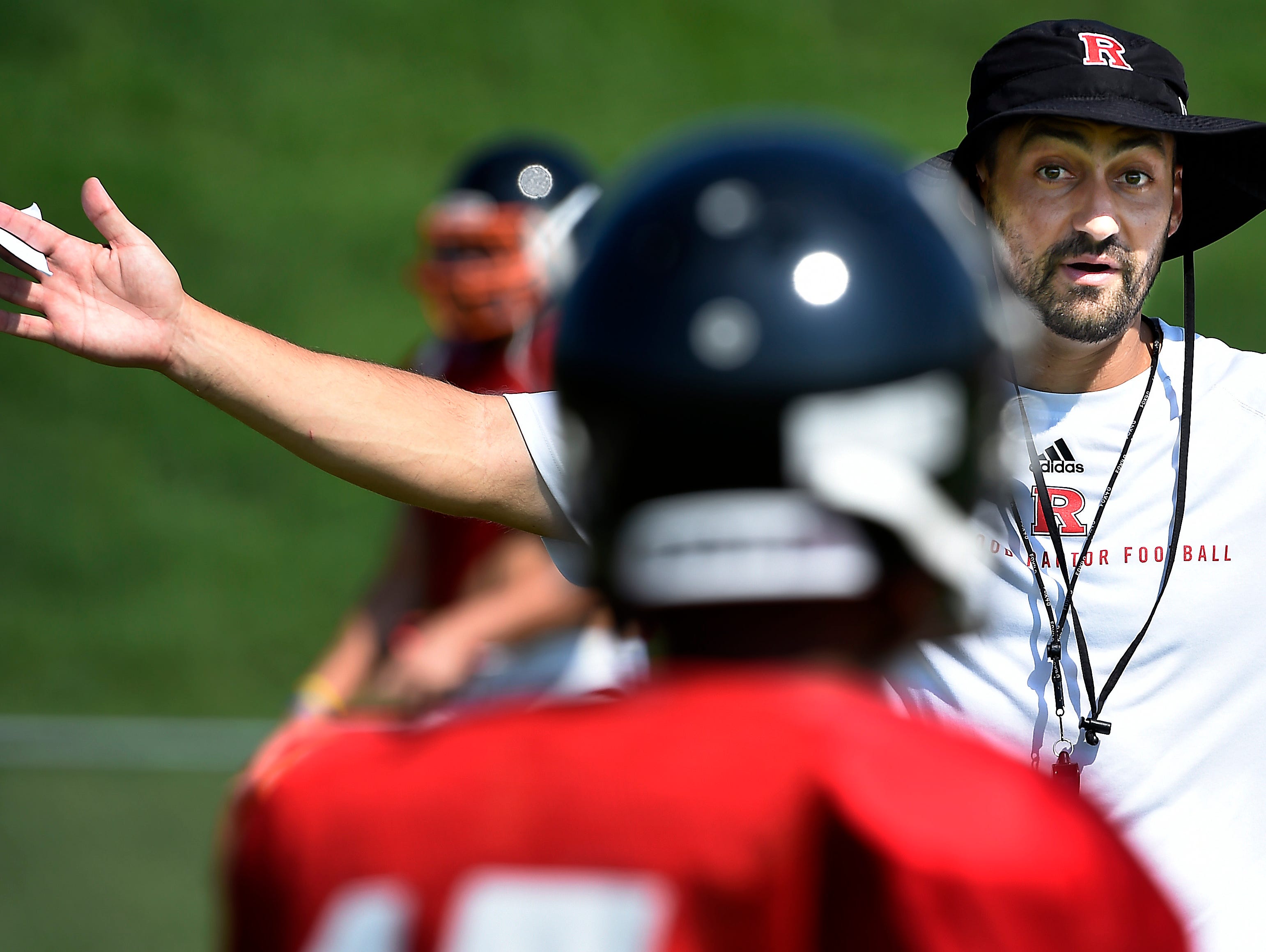 Ravenwood coach Richie Wessman talks with a player during practice Monday, the first day of practice in full pads for Tennessee high school football teams.
