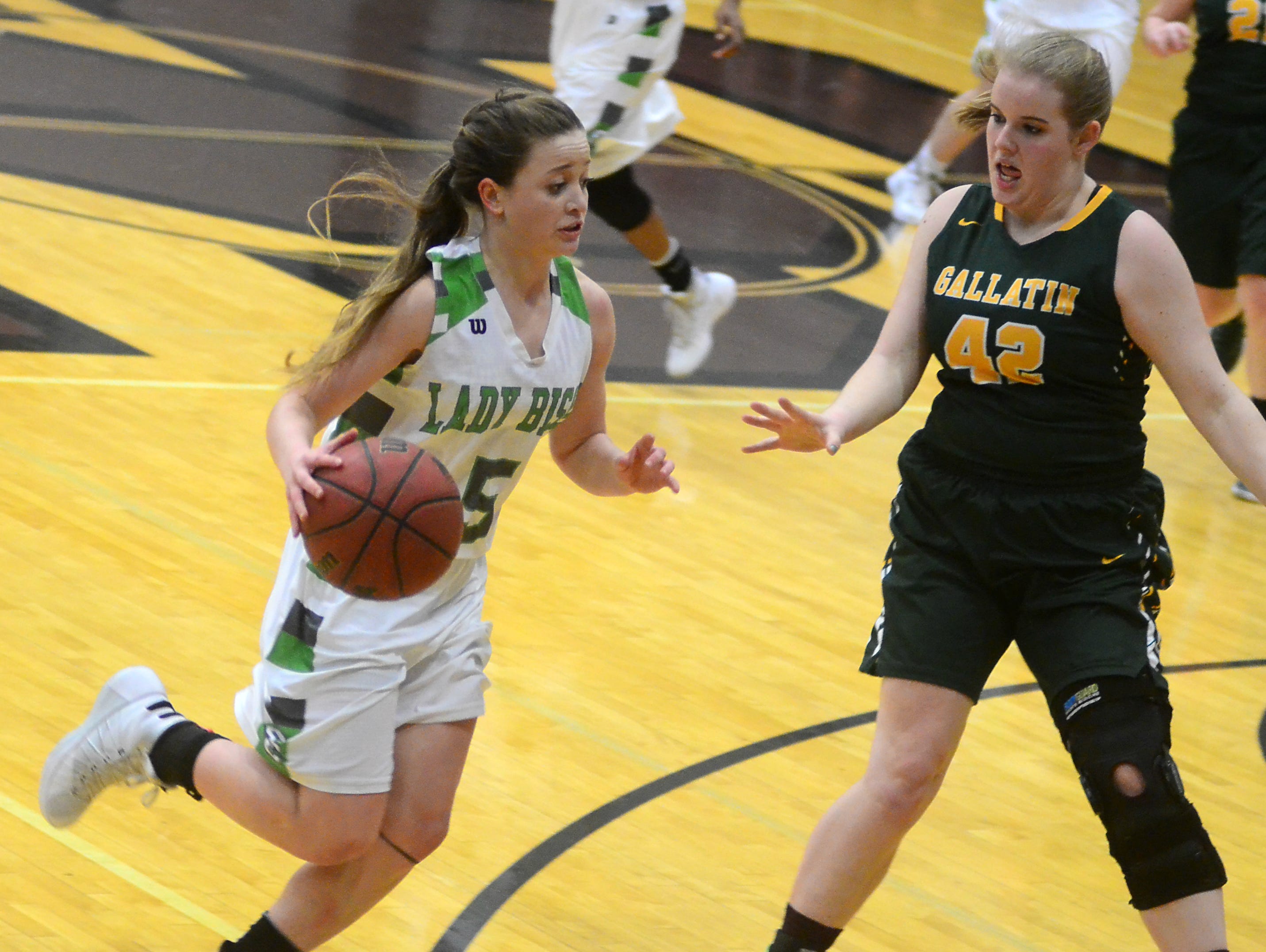 Station Camp High sophomore Cassidy Fry dribbles as Gallatin senior Keile Hale defends during third-quarter action. Fry scored five points.
