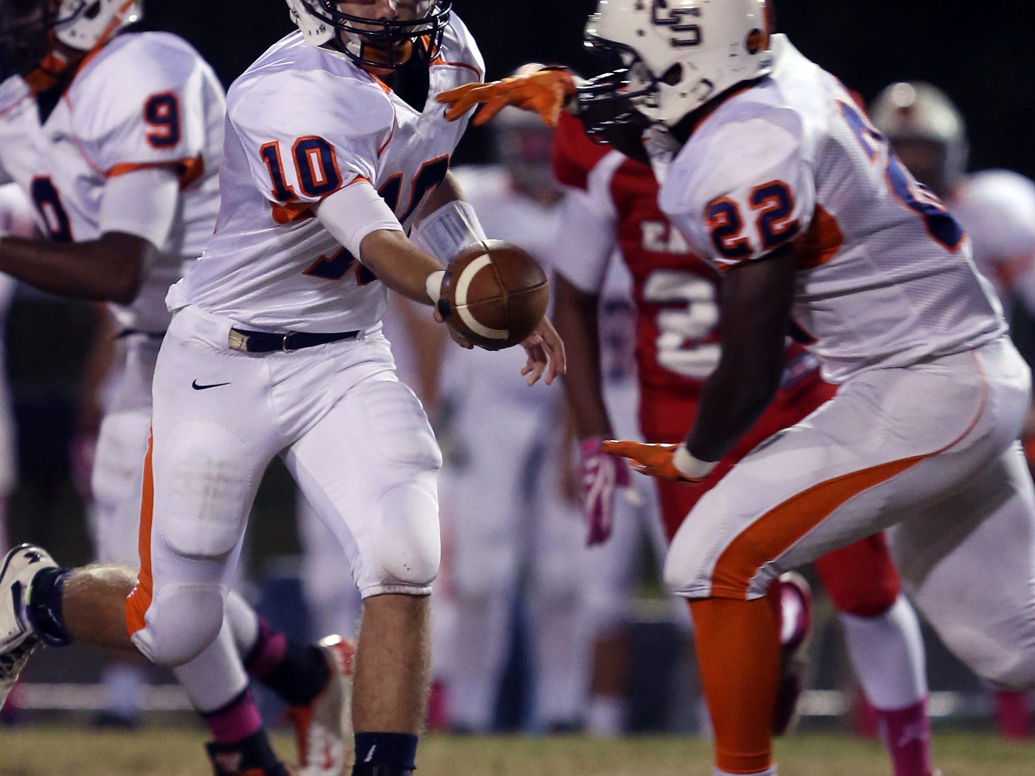 Nashville Christian quarterback Kyle Tidwell hands the ball to Blake Barfield during their game against East Nashville at Tennessee Preparatory School Friday Oct. 24, 2014, in Nashville, Tenn.