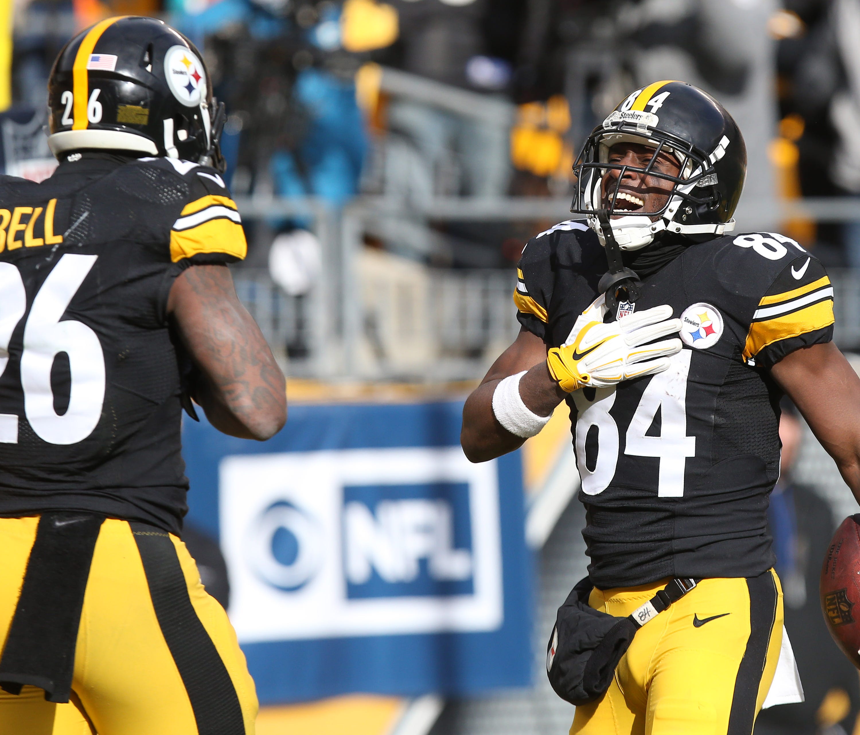 Pittsburgh Steelers wide receiver Antonio Brown (84) celebrates with running back Le'Veon Bell (26) after scoring a touchdown against the Miami Dolphins during the first half in the AFC Wild Card playoff football game at Heinz Field.