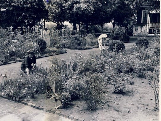 Working in the garden at Farmington in 1960 are, from