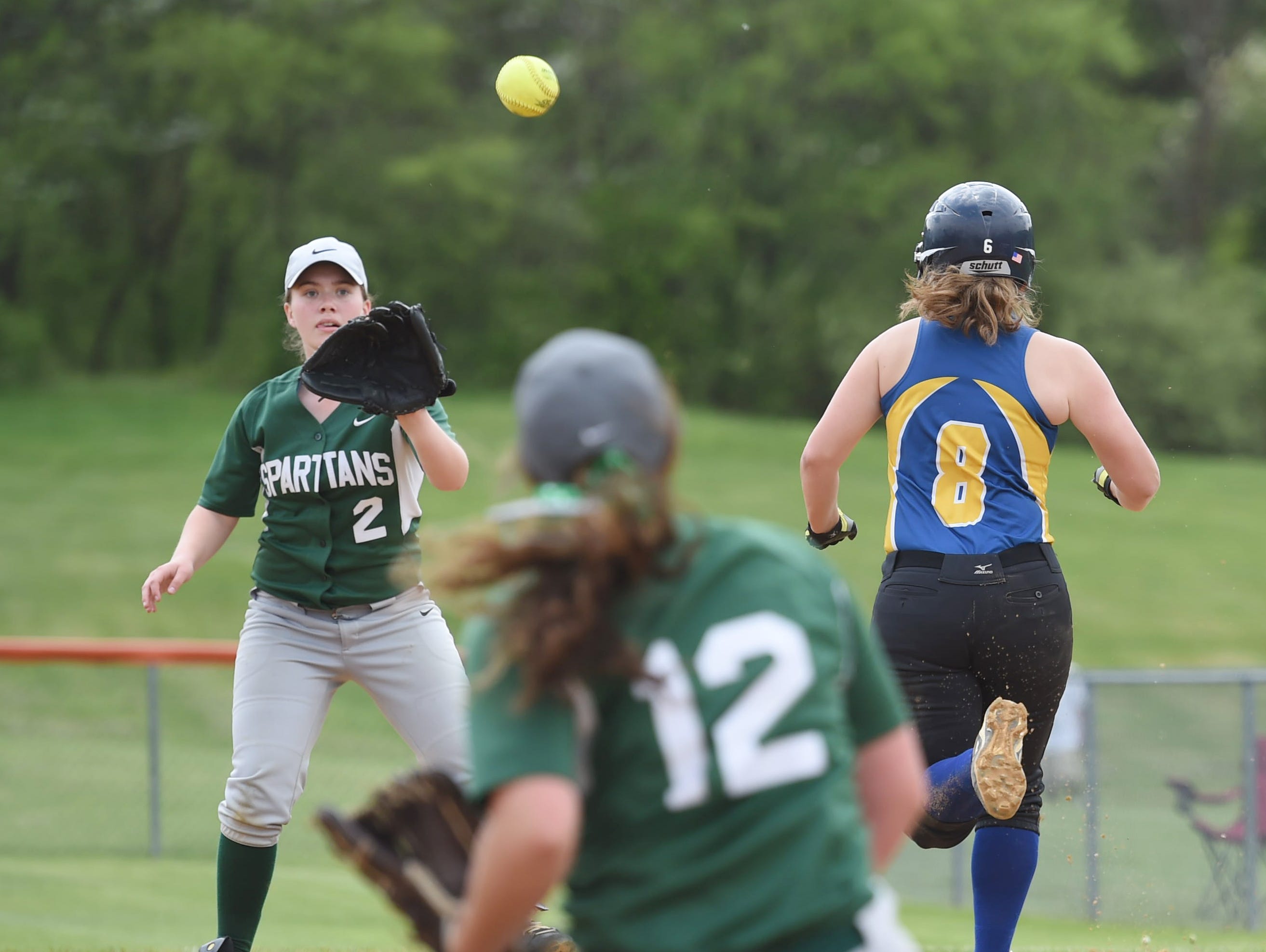 Spackenkill's pitcher, Gabi Mastrantuono recovers a bunt from Ellenville's Mazi Buona and throws to first base, Lexie Close during Saturday's MHAL Division III title game held at Marlboro.