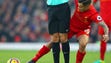 Referee Anthony Taylor stands in the way of Liverpool's