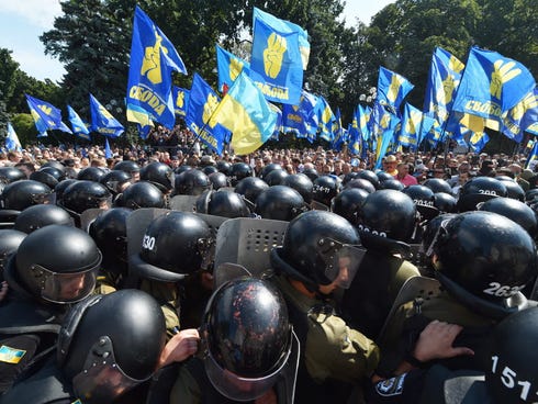 Activists of a few radical Ukrainian parties clash with police officers in front of the parliament in Kiev on Aug. 31.