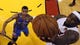 LeBron James lays the ball up past Thunder guard Thabo Sefolosha during Game 4 of the 2012 NBA Finals. Miami won 104-98.