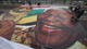 Workers prepare to hang an image of Mandela as they prepare for the World Cup soccer tournament on May 30, 2010, in downtown Johannesburg.