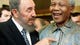 Cuban leader Fidel Castro, left, shares a laugh with Mandela at the World Trade Organization meeting on May 19, 1998, in Geneva.