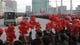 Well-wishers wave flower bouquets as buses carrying North Korean nuclear scientists and other officials pass by in Pyongyang. Scientists and other officials involved in the North's underground nuclear test on Feb. 12 arrived in the capital city Feb. 20 to a celebration.
