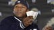 Mayweather tosses a roll of dollars to fans at a news conference for WrestleMania in 2008.