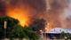 Homes burn as a fire approaches Glenn Ilah on June 30 in Yarnell, Ariz.