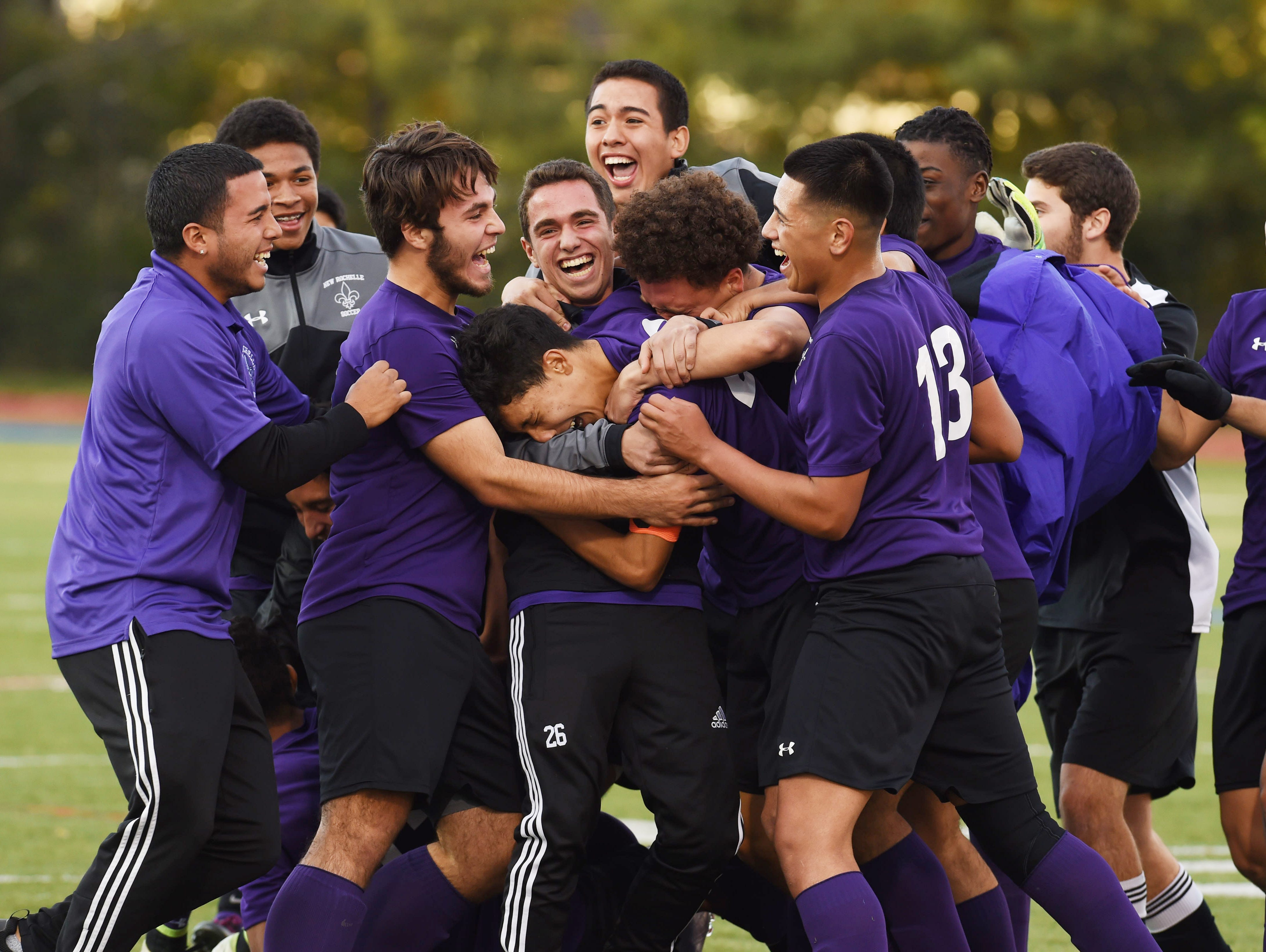 New Rochelle's boys soccer team celebrates after winning Saturday's Class AA regional final against Newburgh.