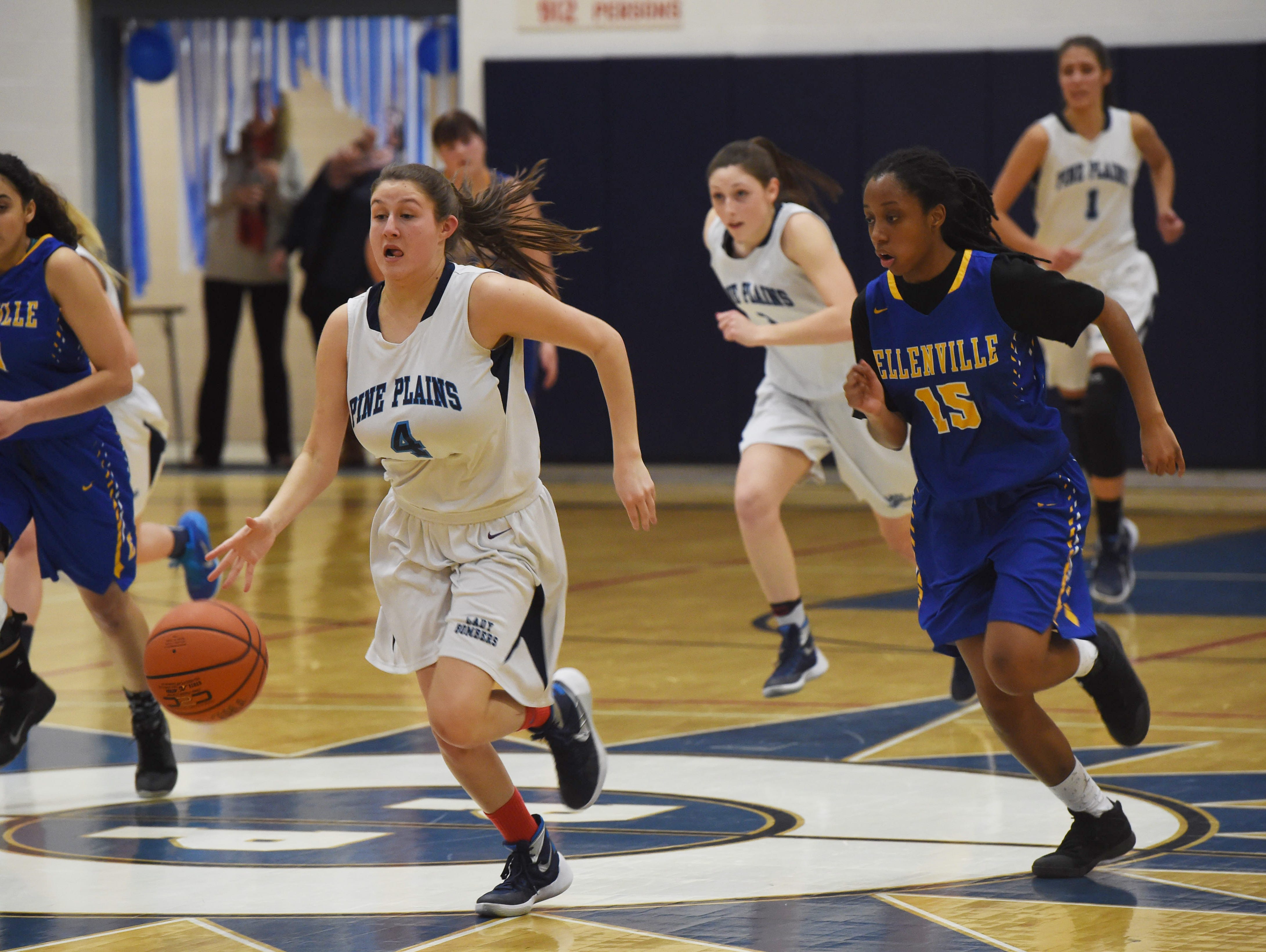 Pine Plains' Tia Fumasoli, center, takes the ball down the court during Tuesday's game against Ellenville.