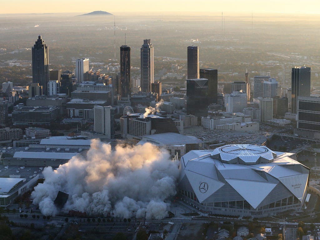 The Georgia Dome is destroyed in a scheduled implosion next to its replacement the Mercedes-Benz Stadium, right, Nov. 20, 2017, in Atlanta. The dome was not only the former home of the Atlanta Falcons but also the site of two Super Bowls, 1996 Olympi