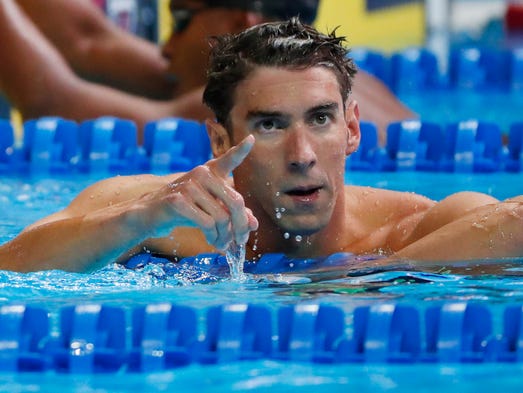 Michael Phelps reacts after the men's 100 butterfly