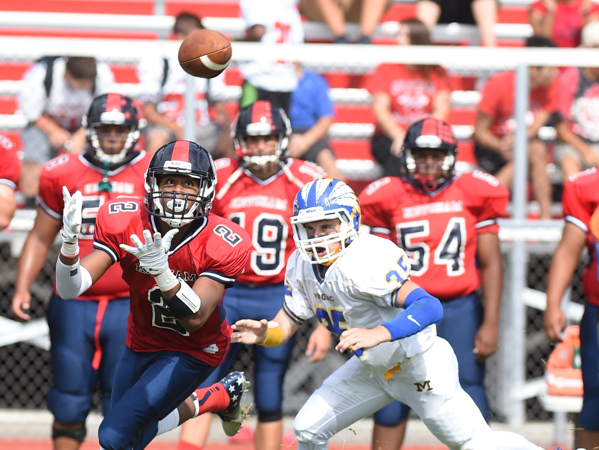 Roy C. Ketcham's Zahir Woody catches a pass as Mahopac's Anthony Ocello tries to catch up to him during Saturday's game at Ketcham.