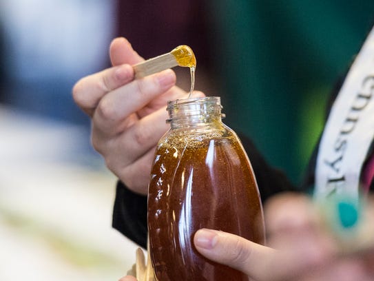 The honey princess hands out free samples of honey