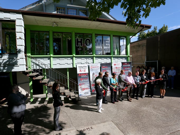 A ribbon is cut the grand reopening of the HOME Youth