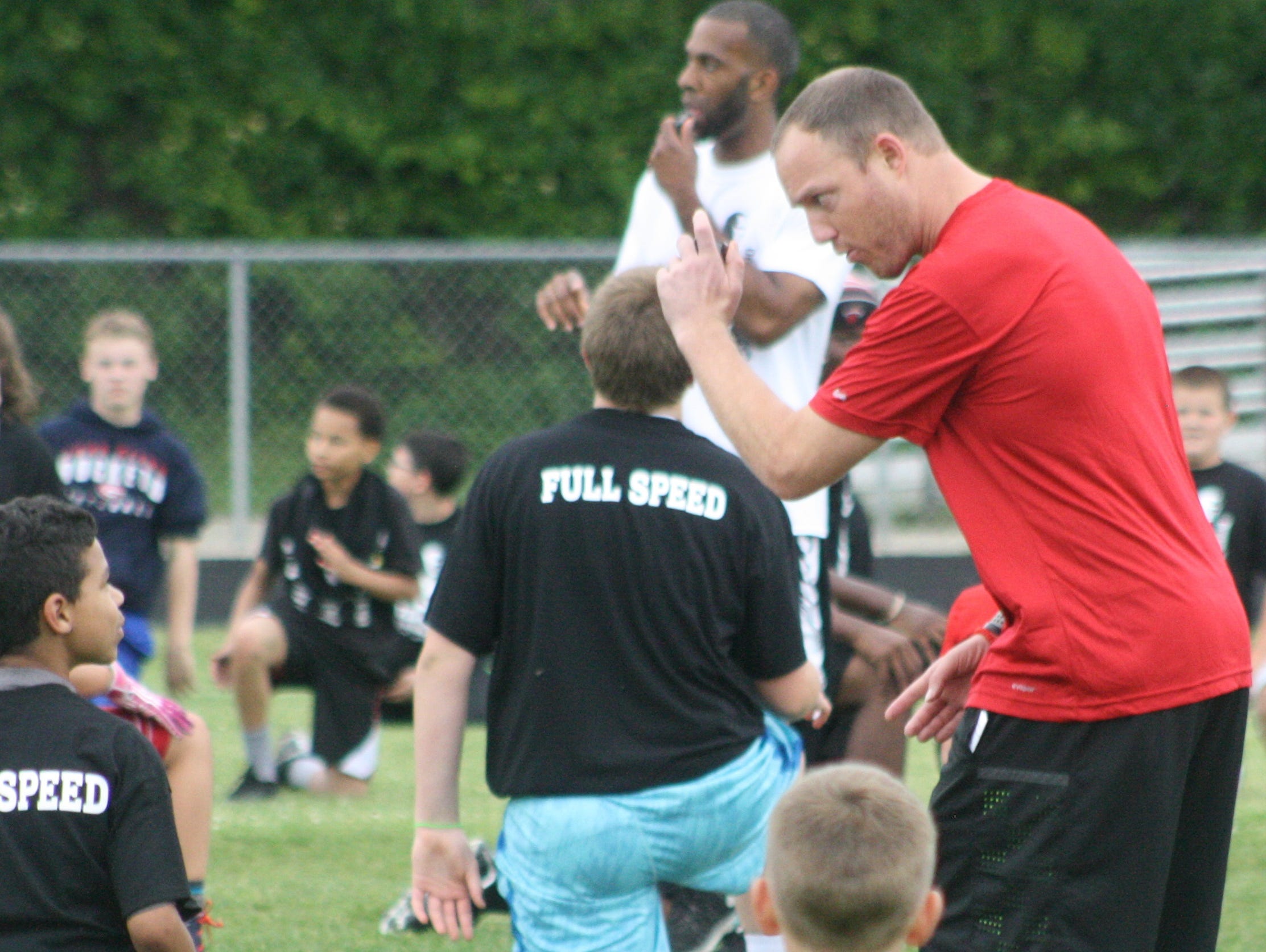 Tim Shaw shares some pointers to a young camper Friday night.