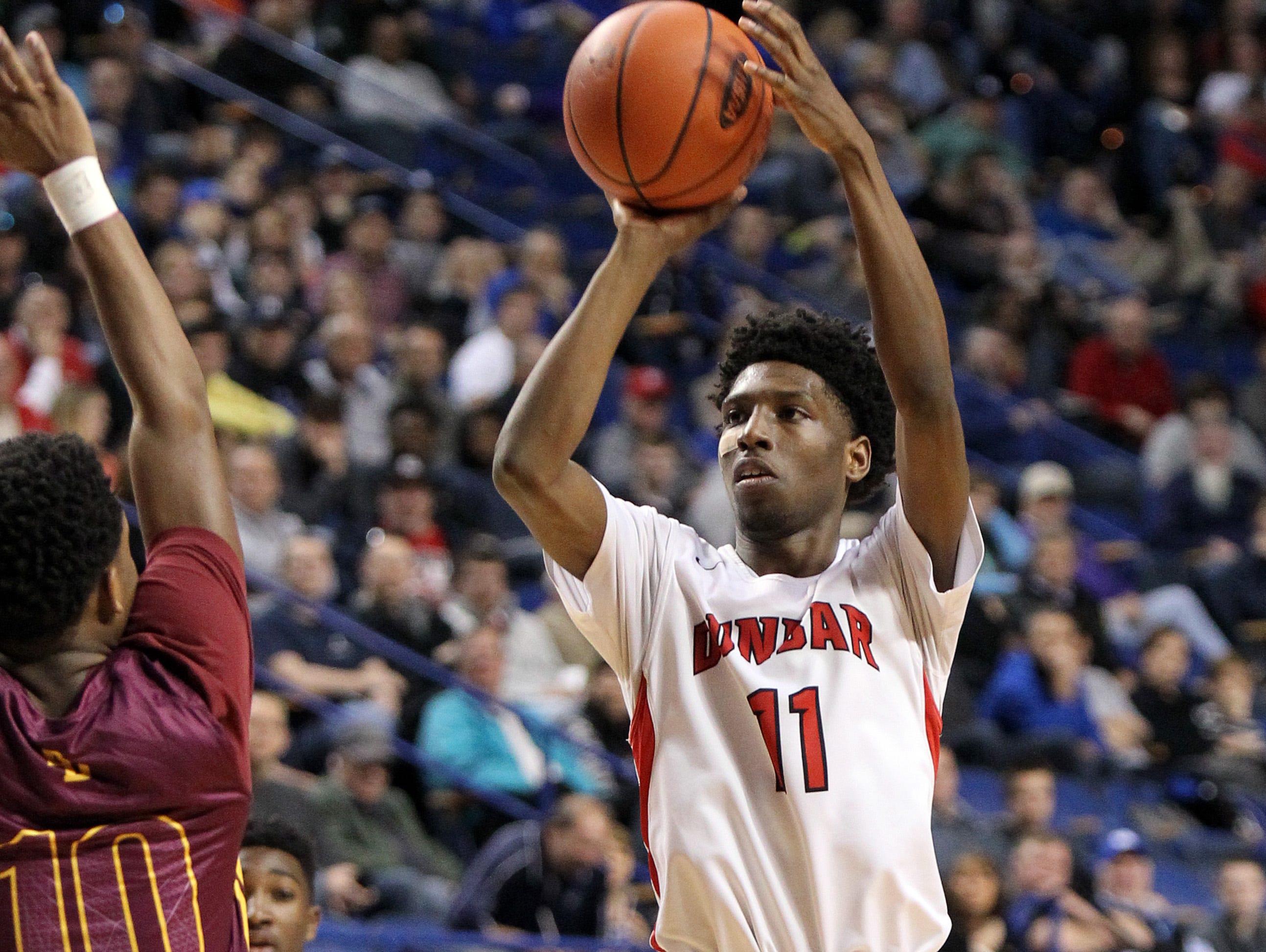 Dunbar's Taveion Hollingsworth is an early favorite for Mr. Basketball. Dunbar's Taveion Hollingsworth, right, shoots while defended by Doss' Nick Anderson during the boys' high school championship basketball game in the KHSAA Sweet 16 in Lexington, Ky., Sunday, March 20, 2016. Dunbar won 61-52. (AP Photo/James Crisp)