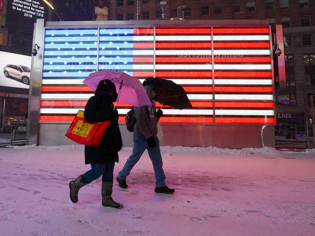 Commuters in Times Square brave the cold snow and wind in New York on Jan. 4, 2018.