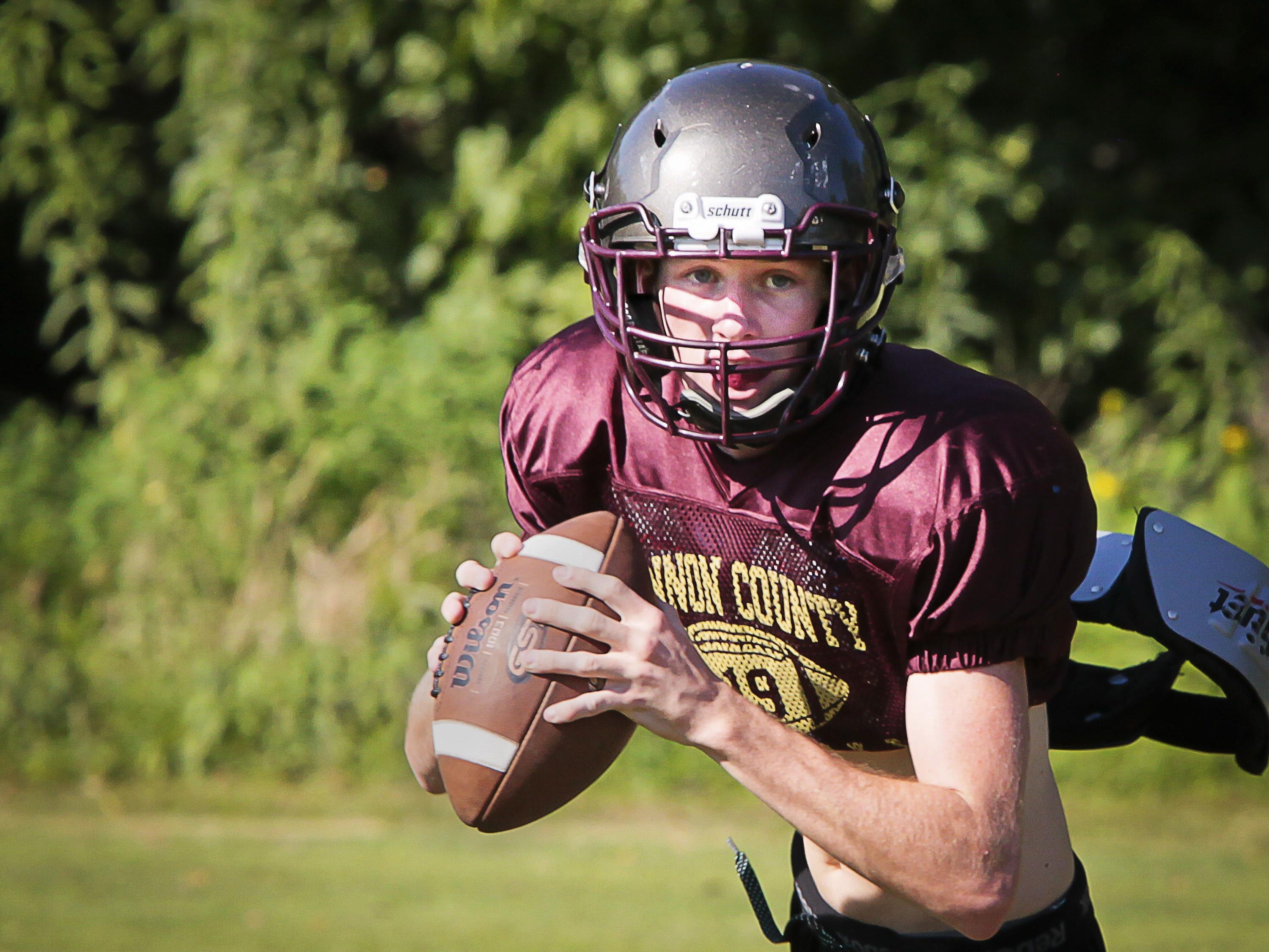 Cannon County quarterback Brady Page rolls out to throw a pass during a recent practice.