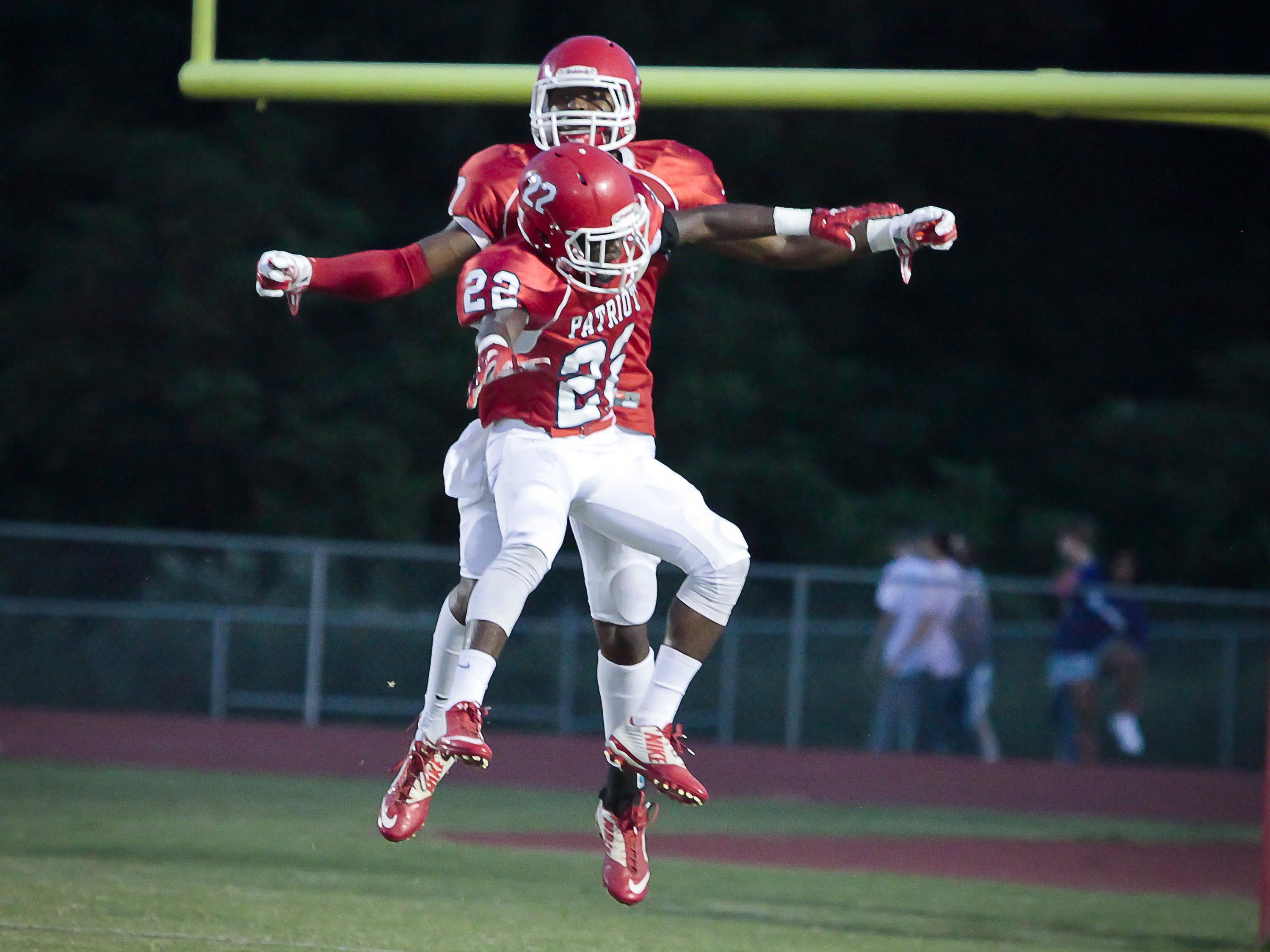 Oakland’s Charles Diawara (22) and JaCoby Stevens (7) celebrate a Stevens touchdown.