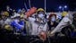 Pro-democracy protesters shout at police forces at