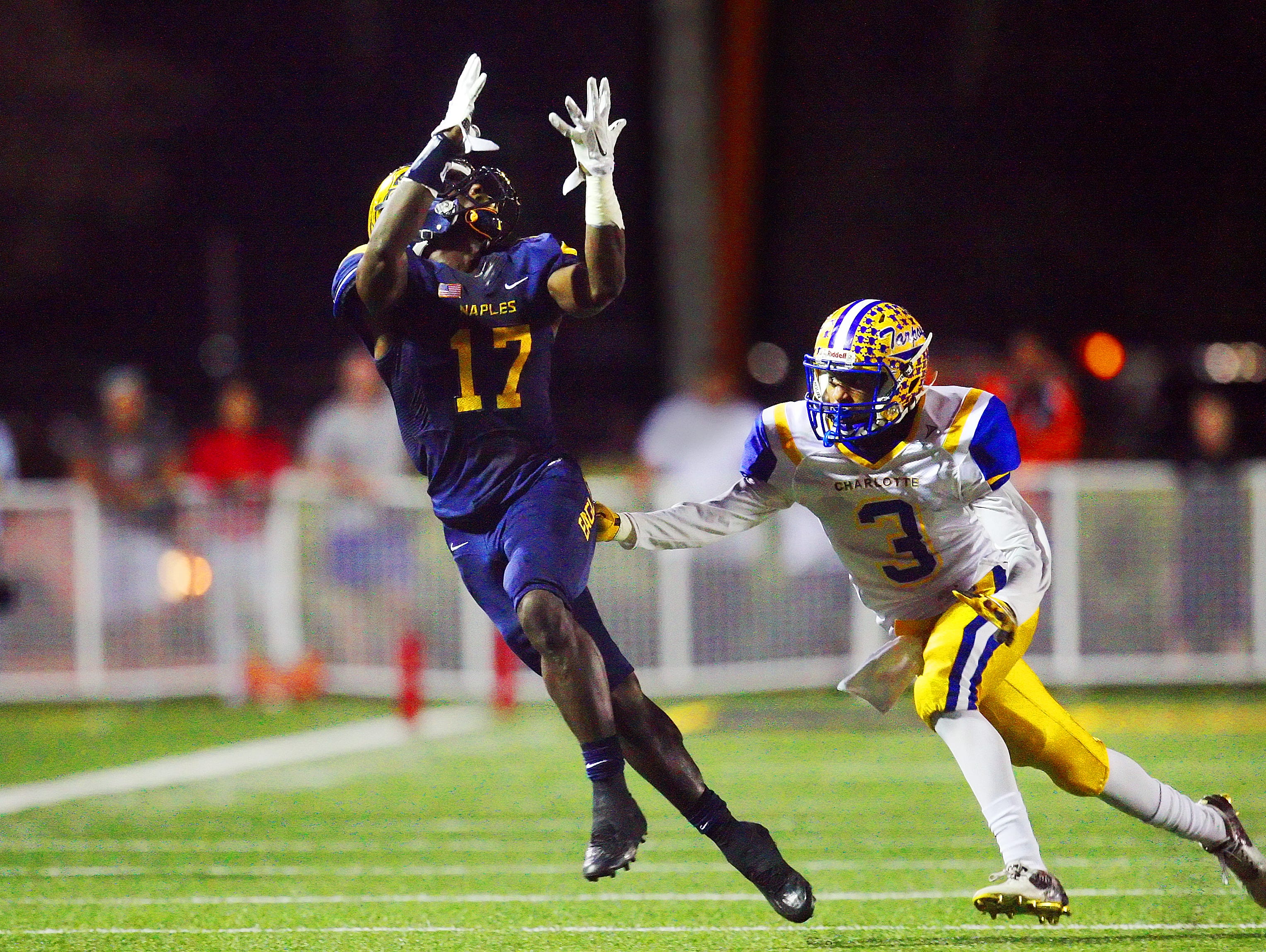 Naples High School's Tyler Byrd leaps for a pass against Charlotte during the Class 6A Region 3 final Friday at Naples High School. Naples beat Charlotte 35-0.