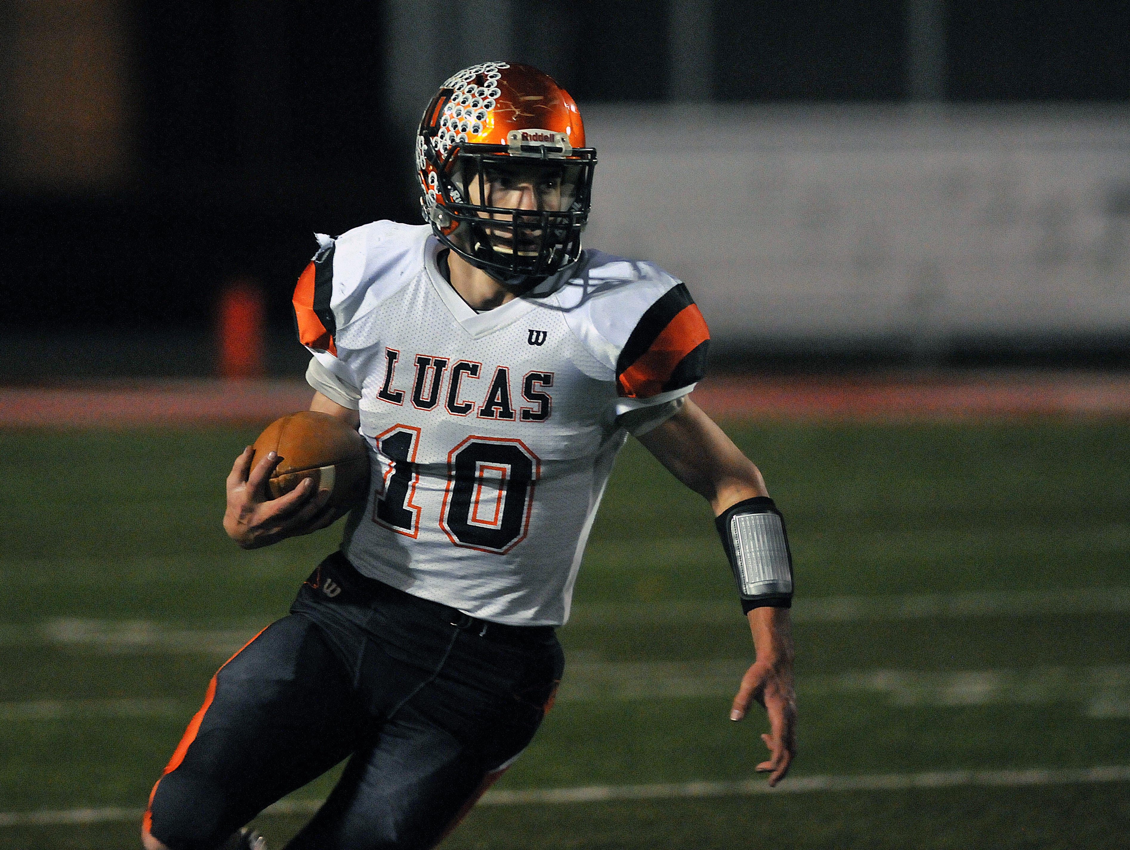 Mason Galco, a senior running back at Lucas, runs the ball against Tiffin Calvert in a Division VII playoff game this year. Galco was named News Journal Co-Offensive Player of the Year.