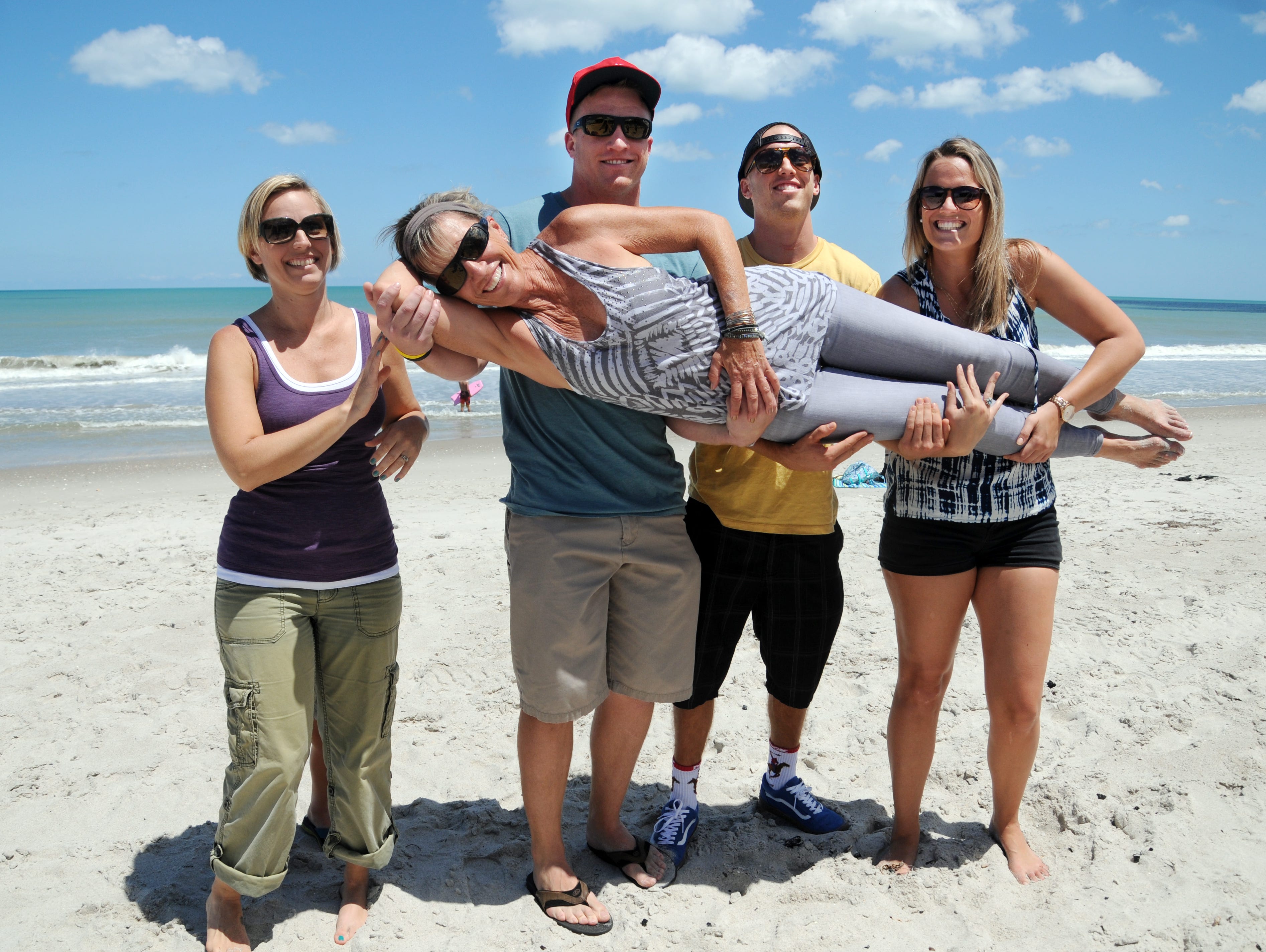 Linda Anderson gets held up by her children Tiffany Brown, and Mason, Calvin and Madison Smith on the beach in Satellite Beach Saturday afternoon.