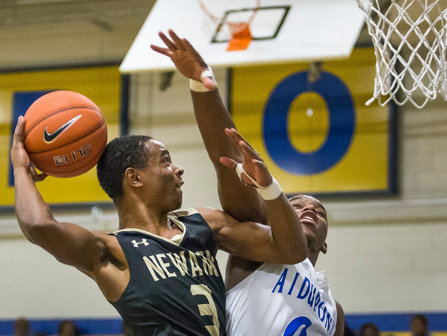 Newark's Kineph Turner puts up a shot as A.I.'s Nasir Comeger defends in the second quarter of Newark's 52-51 win over A.I. duPont High School in Greenville on Tuesday evening.