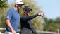 PGA golfer Dustin Johnson talks to Rory McIlroy on