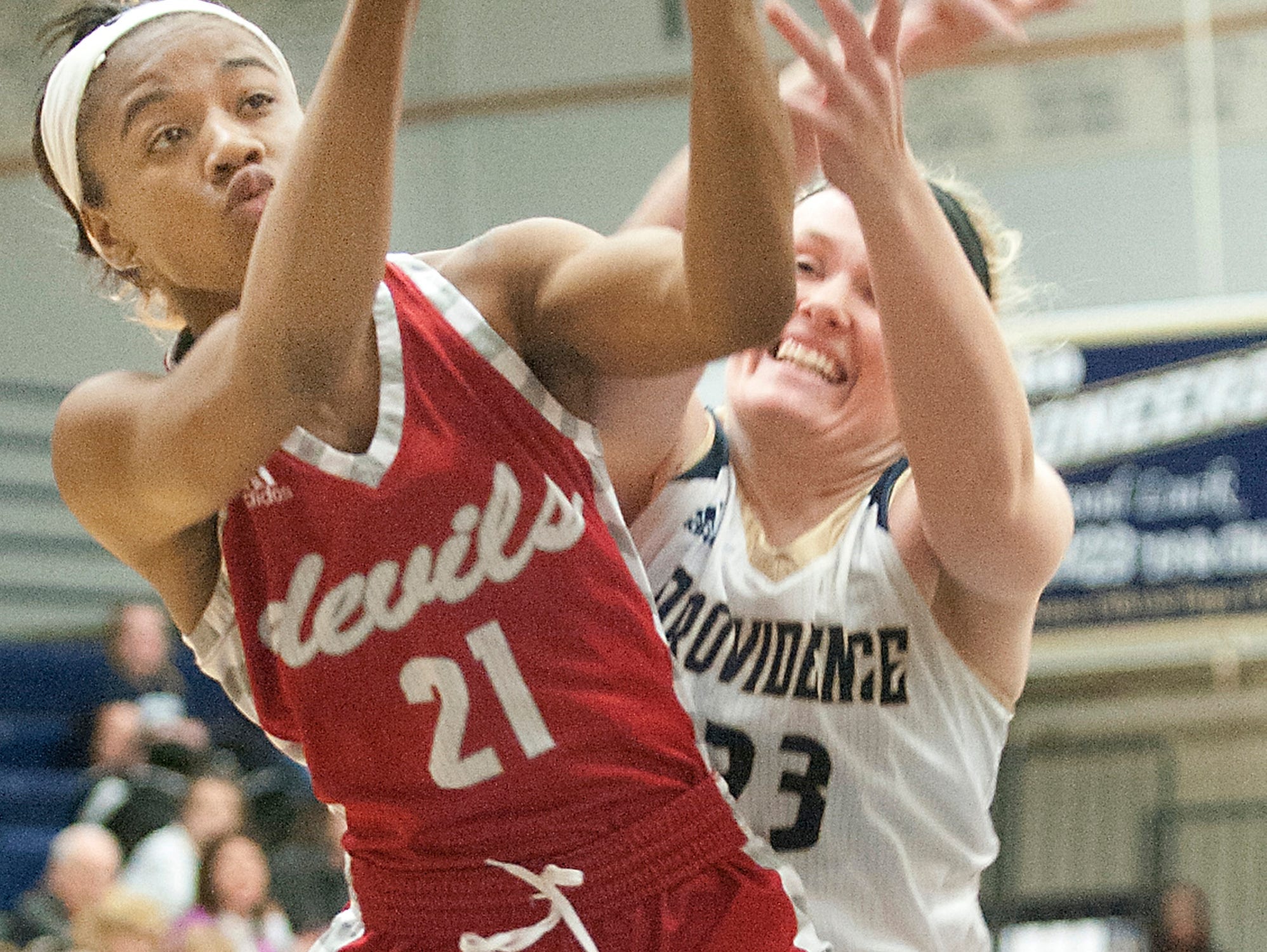 Jeffersonville guard Jhala Henry puts up a shot as Providence forward Claire Rauck defends the basket. 03 January 2017