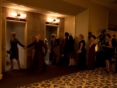 Two women in 'What Happens in Vegas' mode opt for the men's room to skip the line outside the ladies room.