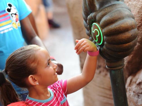 Isabella Rosario uses her MagicBand+ to ride Under the Sea - Journey of the Little Mermaid at Walt Disney World in Florida.