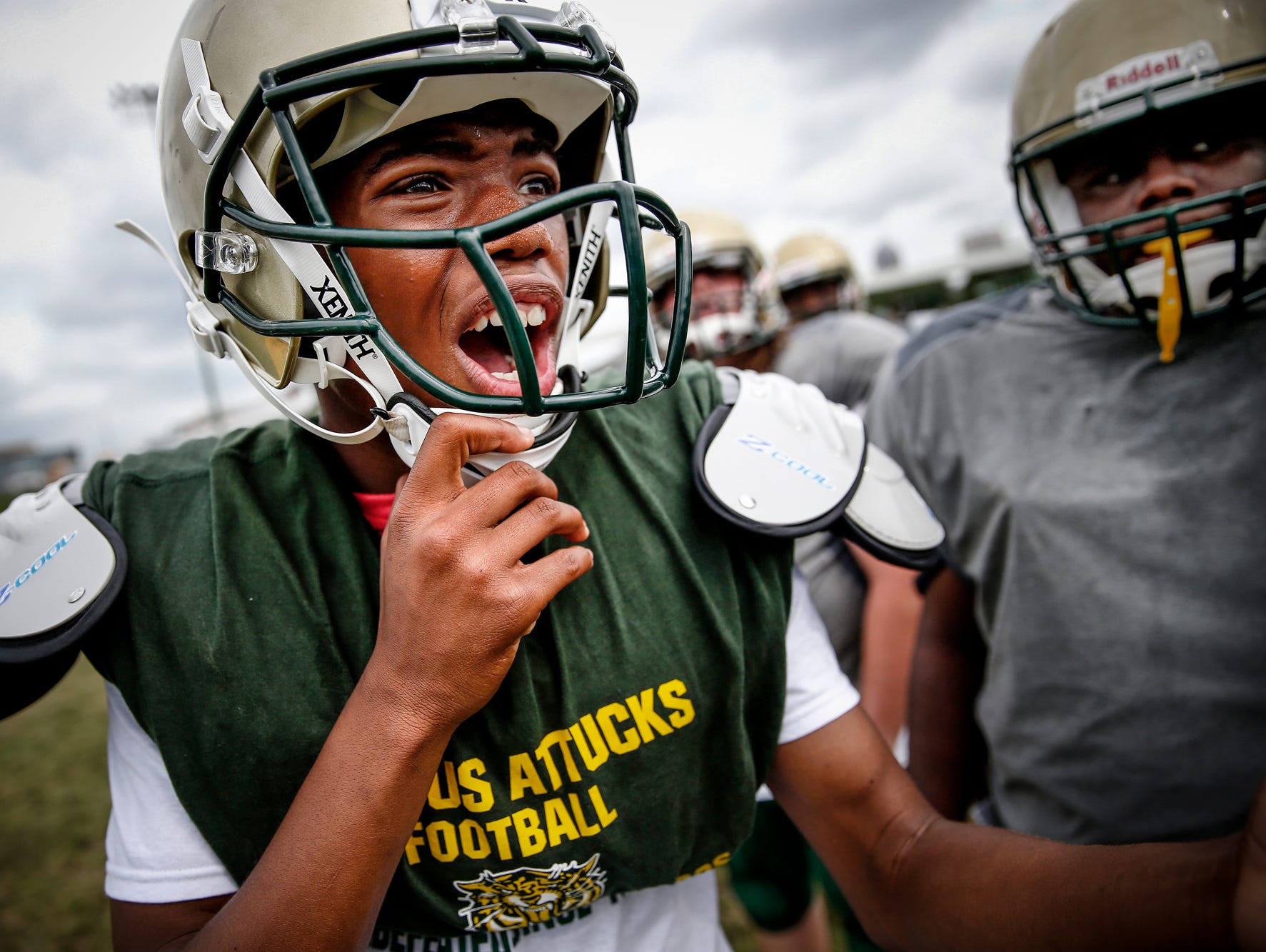 Crispus Attucks freshman quarterback Quanzell Jones gets after his team in the huddle during practice at Alonzo Watford Athletic Field on Aug. 17, 2016.