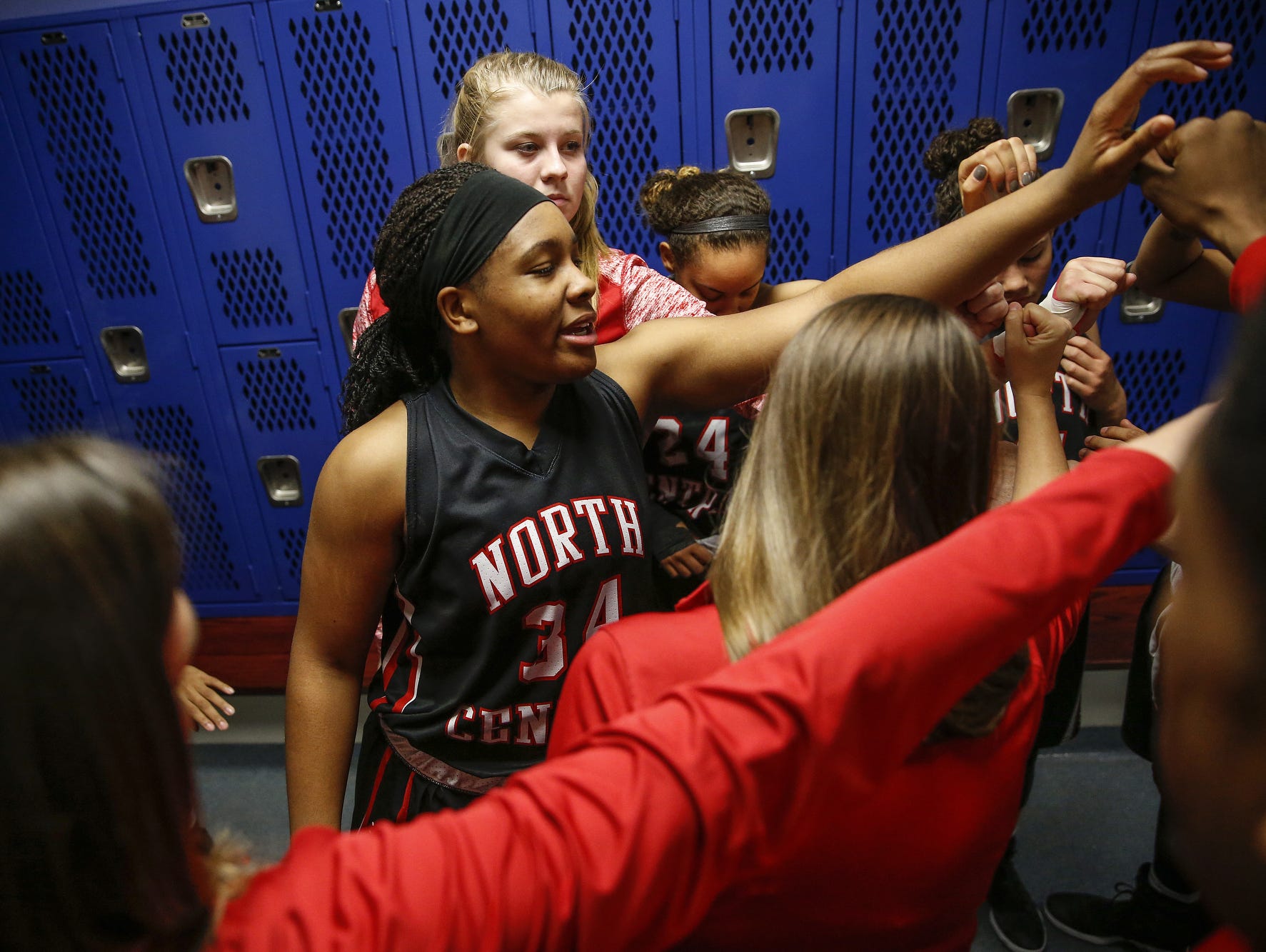 North Central Panthers' Ajanae« Thomas (34) breaks a huddle with her team after the Panthers' win against the Carmel Greyhounds at Carmel High School on Friday, Dec. 16, 2016.