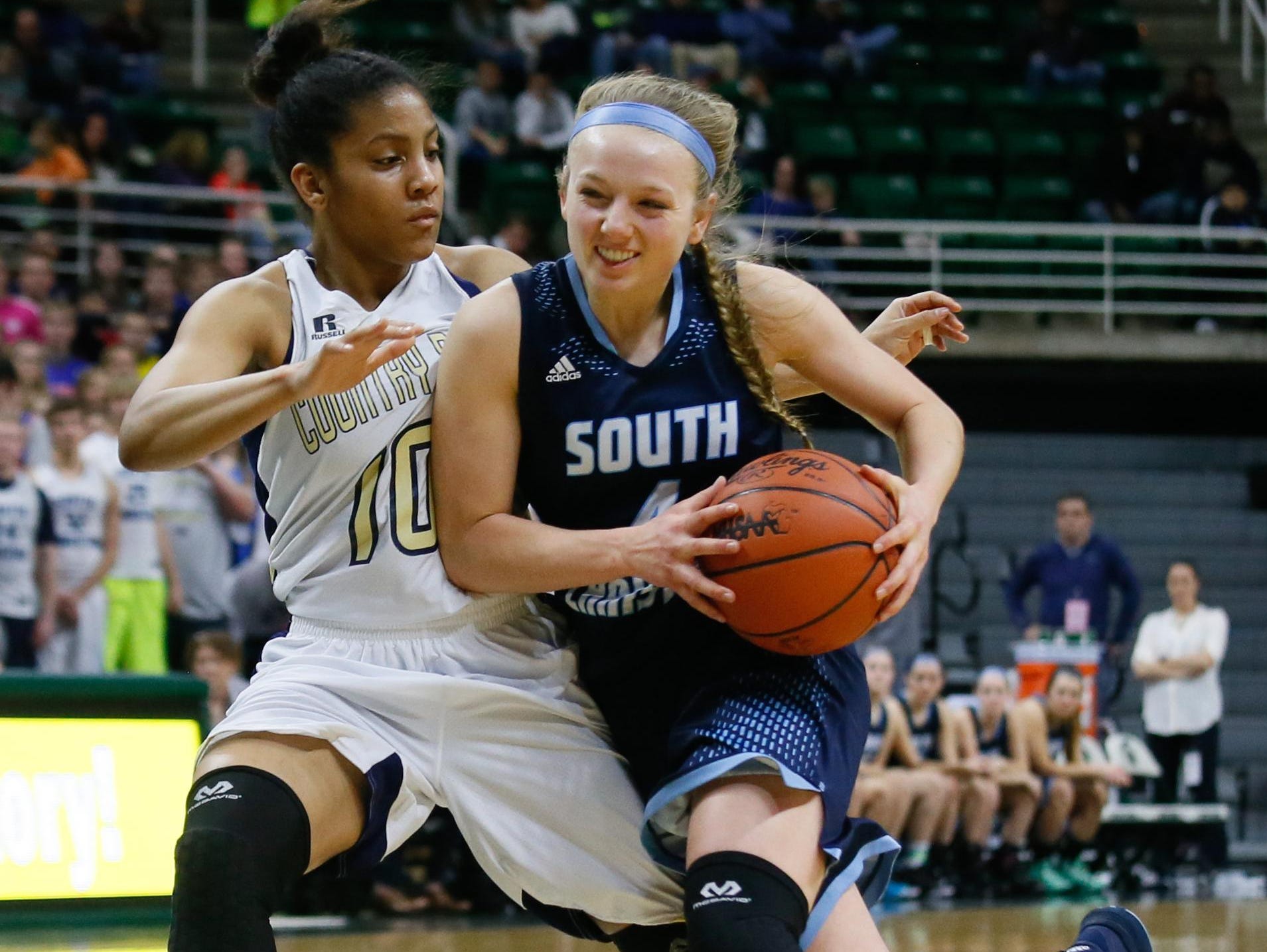Grand Rapids South Christian's Jennifer DeBoer drives the lane Friday against Birmingham Detroit Country Day's Arika Tolbert. “We weren’t expected to be here, so we were able to just go out and play,” said DeBoer.