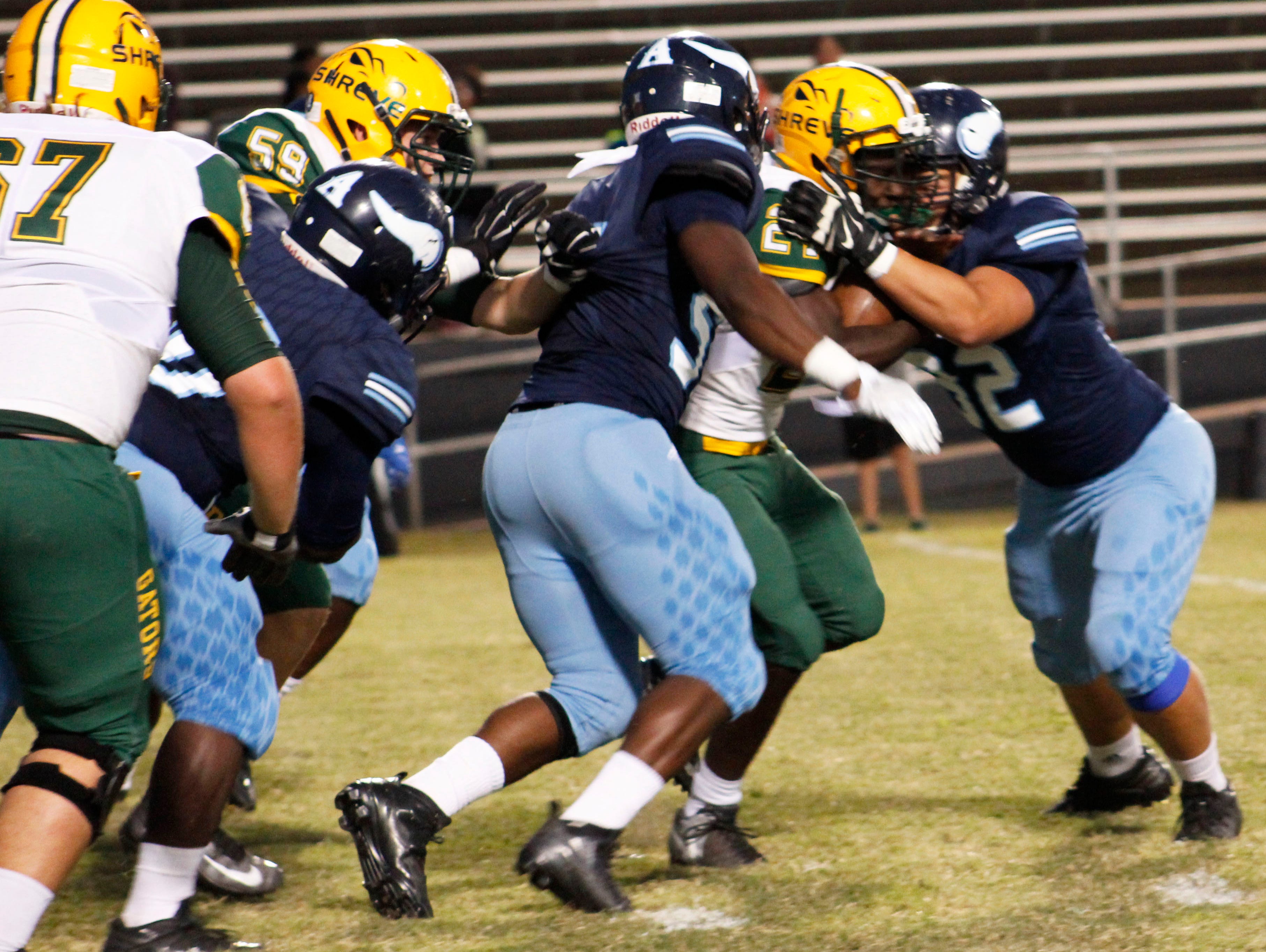 The Airline defense tries to wrap up Captain Shreve's Demarcus McCall during Friday's game.