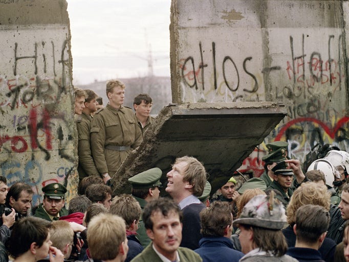 West Berliners crowd in front of the Berlin Wall early