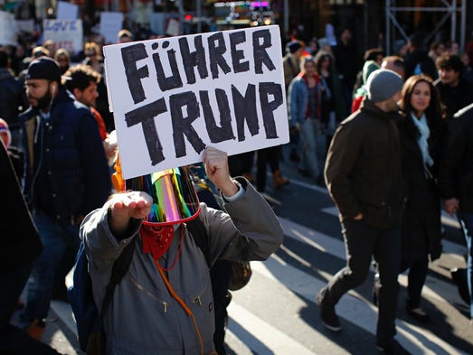 A man holds a poster during a protest against U.S.