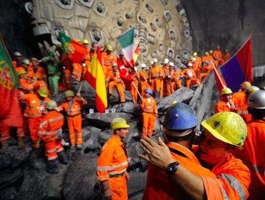 Miners hug after a giant drilling machin