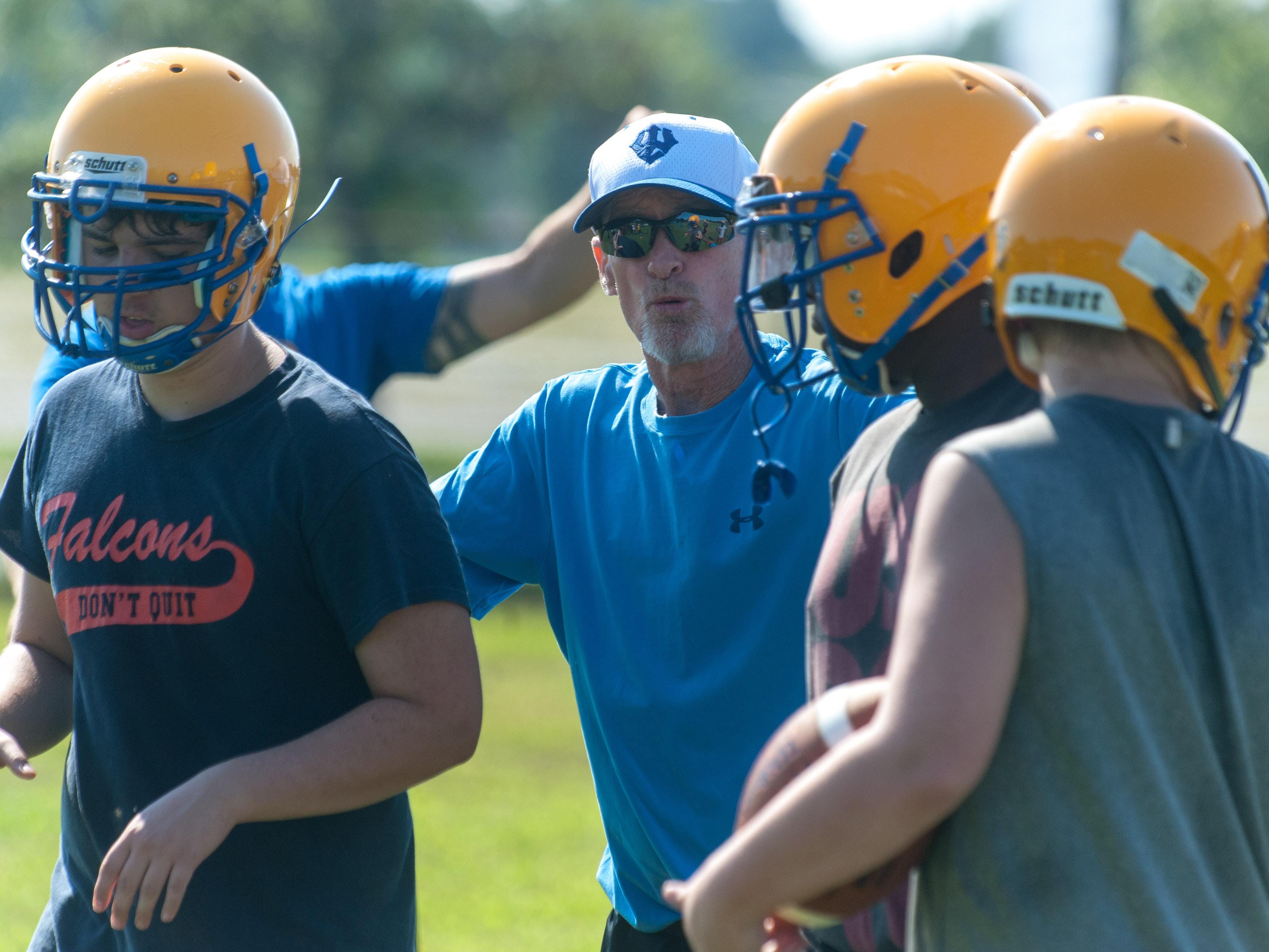 Wicomico High coaches work with linemen during the second day of practice.