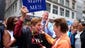New York City mayor Bill de Blasio applauds as a participant