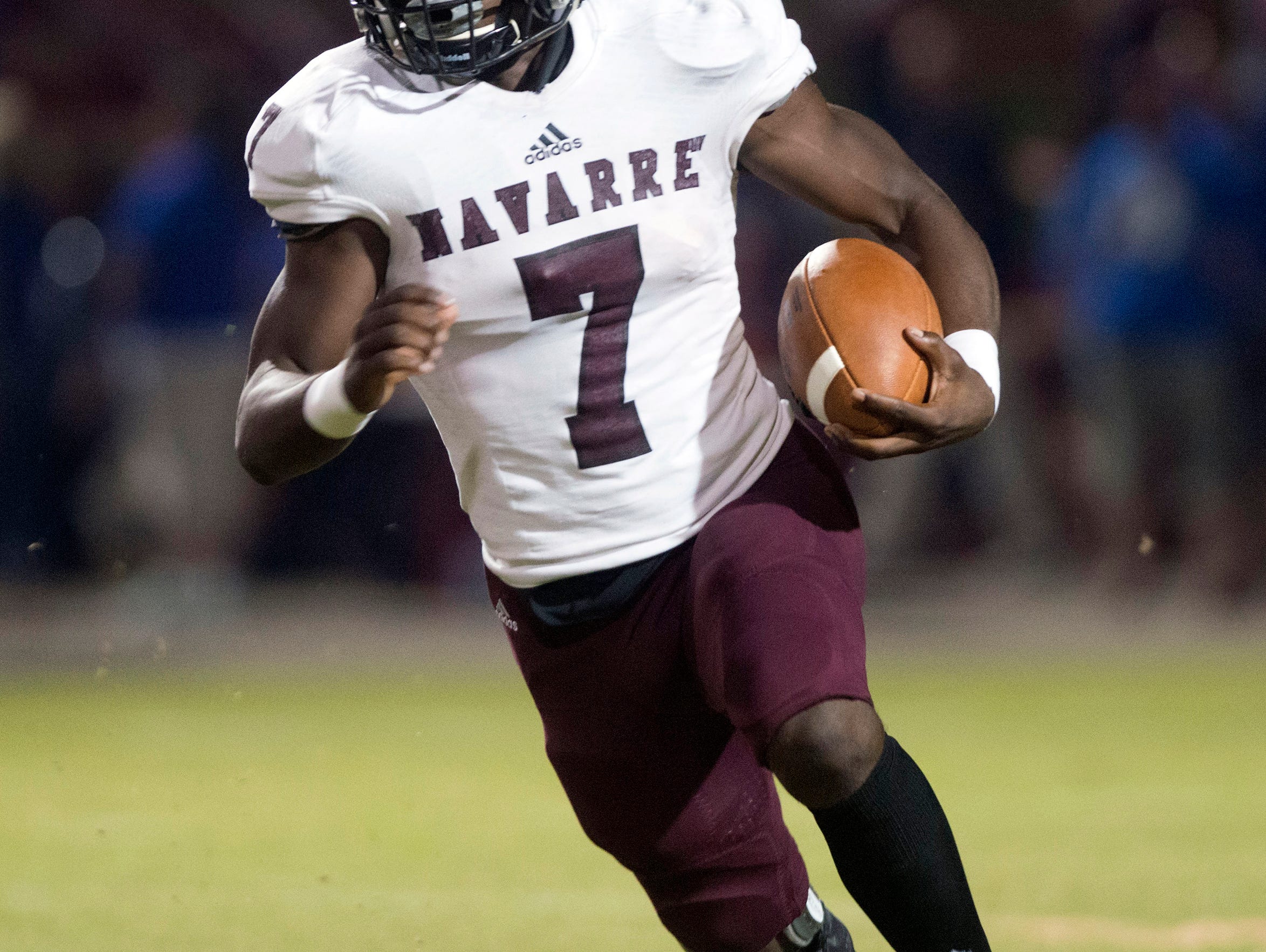 Navarre High School star running back Michael Carter, (No. 7) looks for running room against the Pace High School defense during Friday night's District 2-6A matchup.