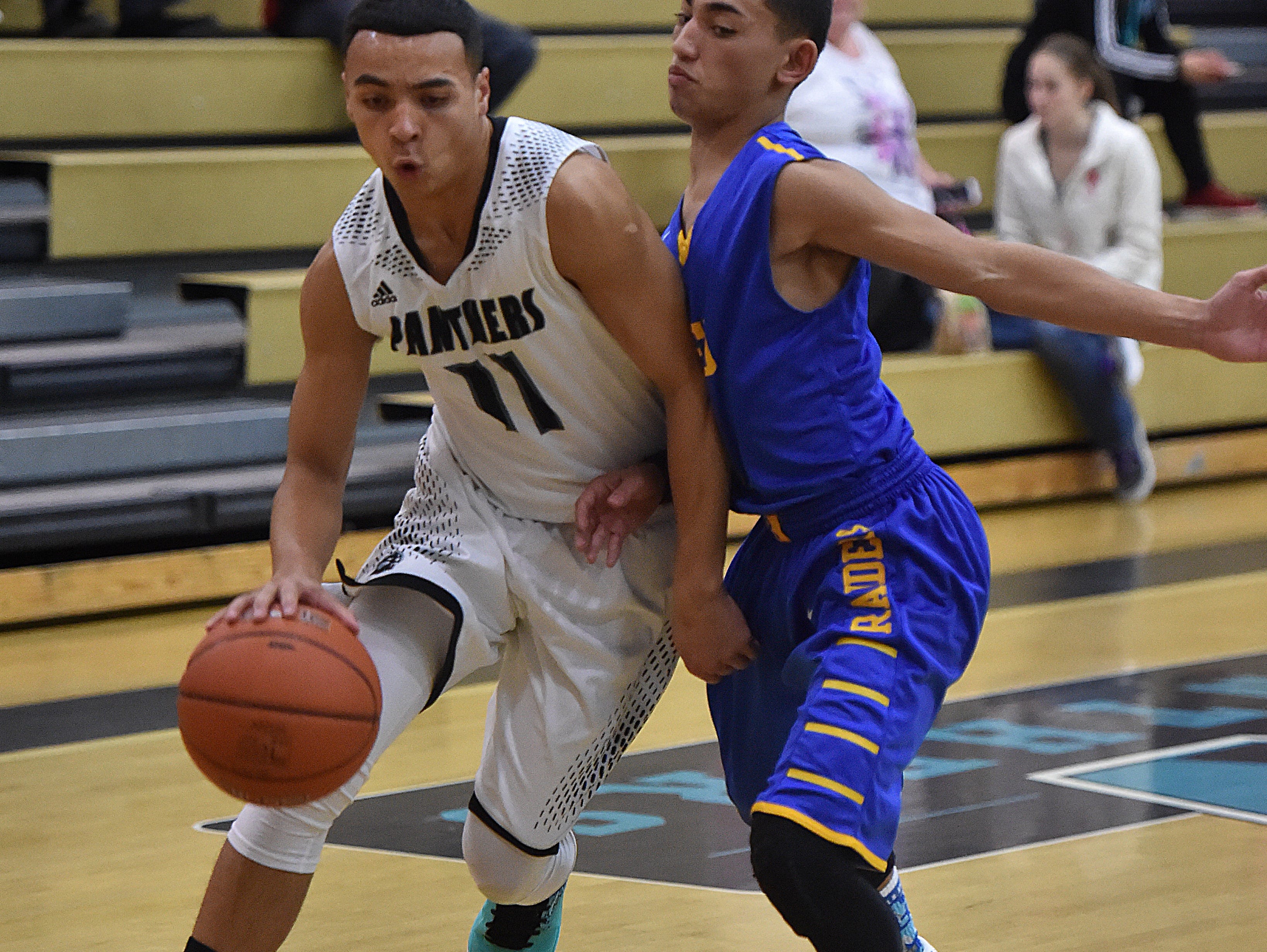 North Valleys' Jalen Meadors drives against Reeds' Issac Nieves during Tuesday's game at North Valleys.